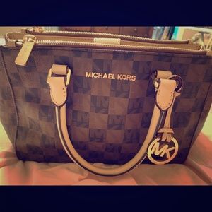 Checkered cross body Michael kors purse.
